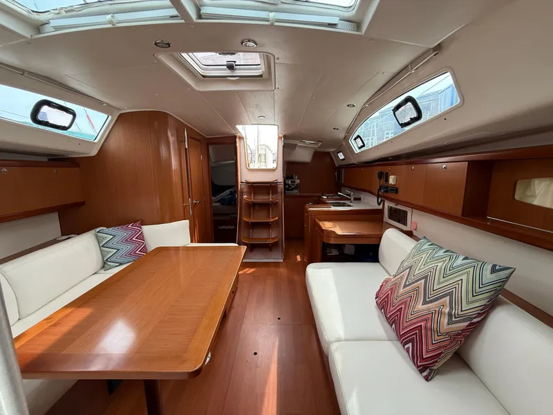 Slide: The Image of Interior of 2008 Beneteau Oceanis 40 sailboat with wood finish and cozy seating area. - 33