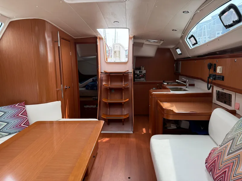 Slide: The Image of Interior of 2008 Beneteau Oceanis 40 sailboat with wood finish and cozy seating area. - 34