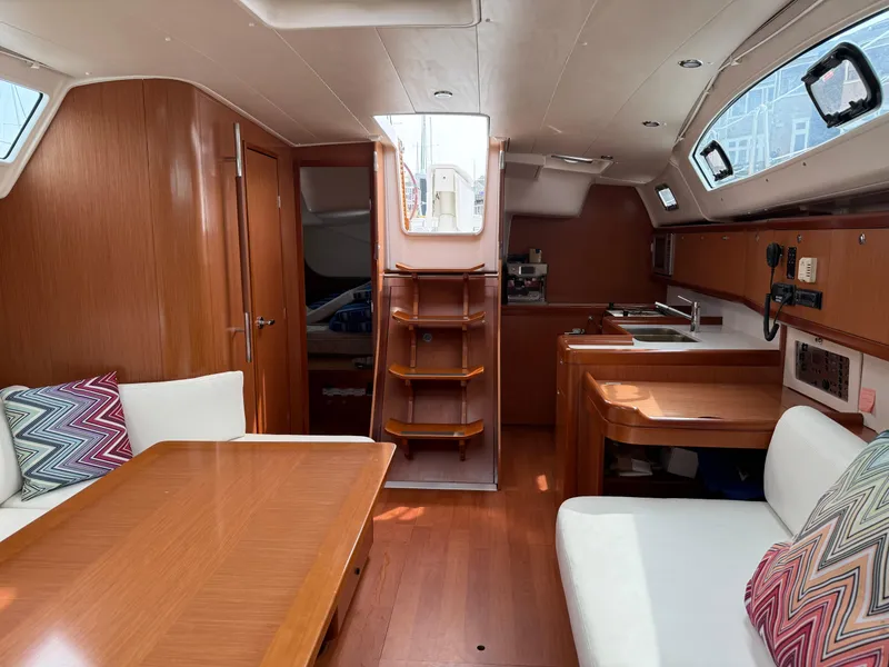 Slide: The Image of Interior of 2008 Beneteau Oceanis 40 sailboat, featuring wood finish and cozy seating area. - 35