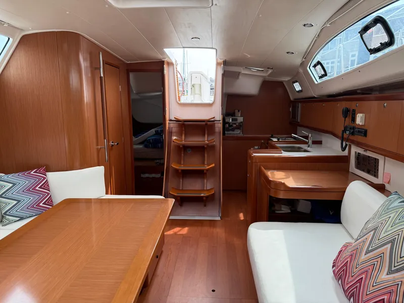 Slide: The Image of Interior of 2008 Beneteau Oceanis 40 sailboat with wood finish and cozy seating area. - 36