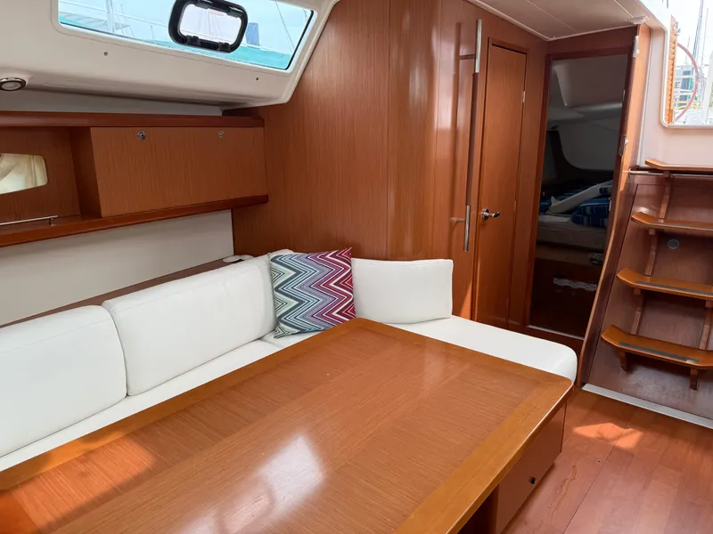 Slide: The Image of Interior of 2008 Beneteau Oceanis 40 yacht with wooden finish and white seating. - 37