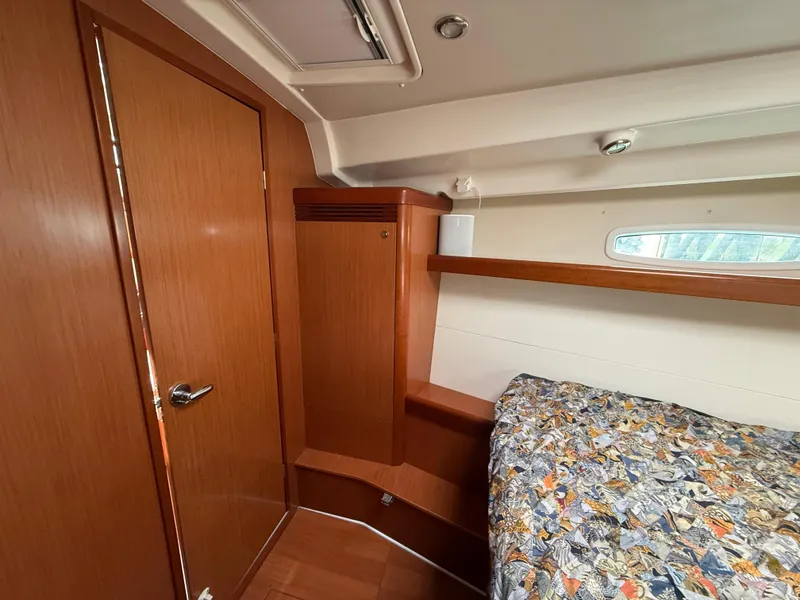 Slide: The Image of Interior cabin of 2008 Beneteau Oceanis 40 sailboat with wooden finish and patterned bedding. - 5