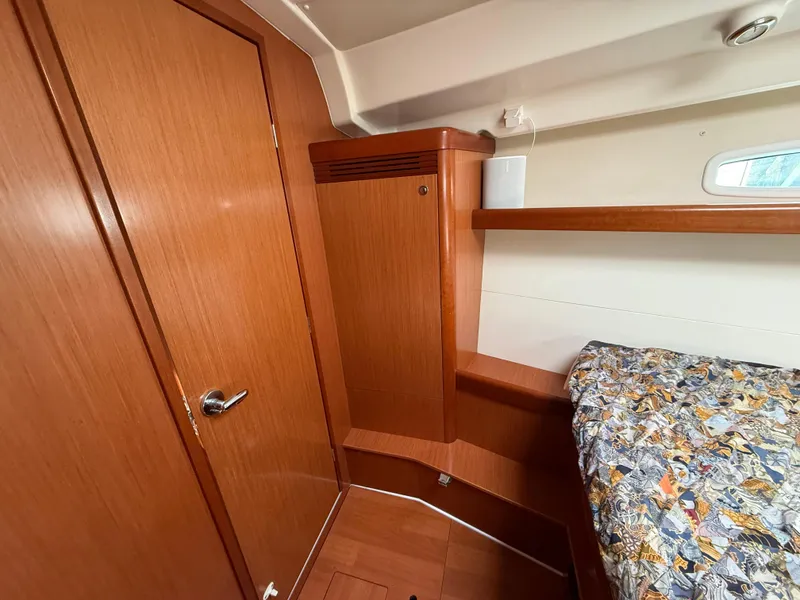 Slide: The Image of Interior cabin of 2008 Beneteau Oceanis 40 sailboat with wooden finish and patterned bedding. - 6
