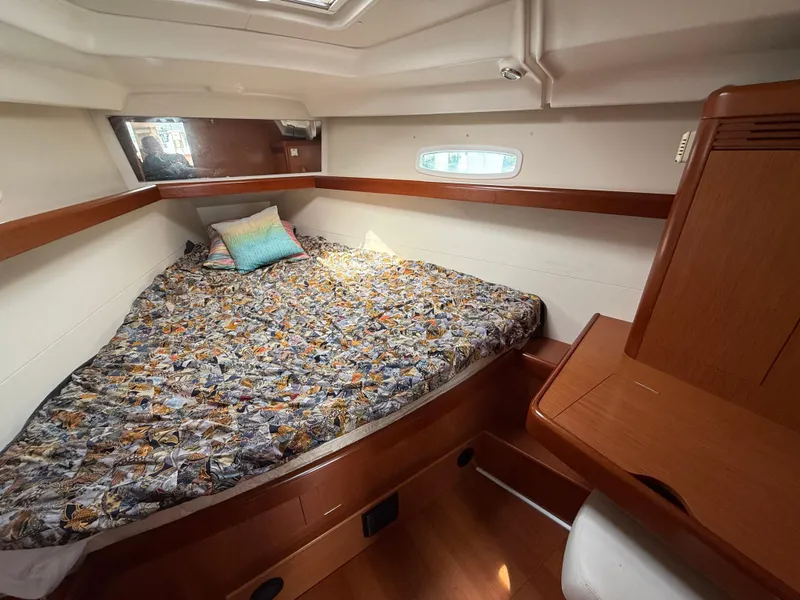 Slide: The Image of Cozy cabin interior of 2008 Beneteau Oceanis 40 sailboat with patterned bedding. - 7