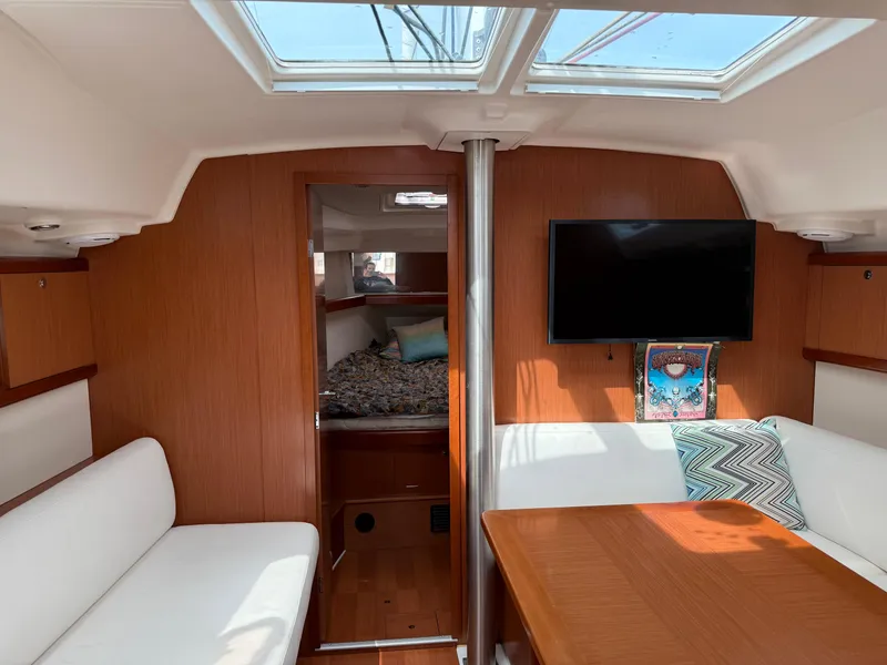 Slide: The Image of Interior of 2008 Beneteau Oceanis 40 sailboat with cozy seating and modern amenities. - 9