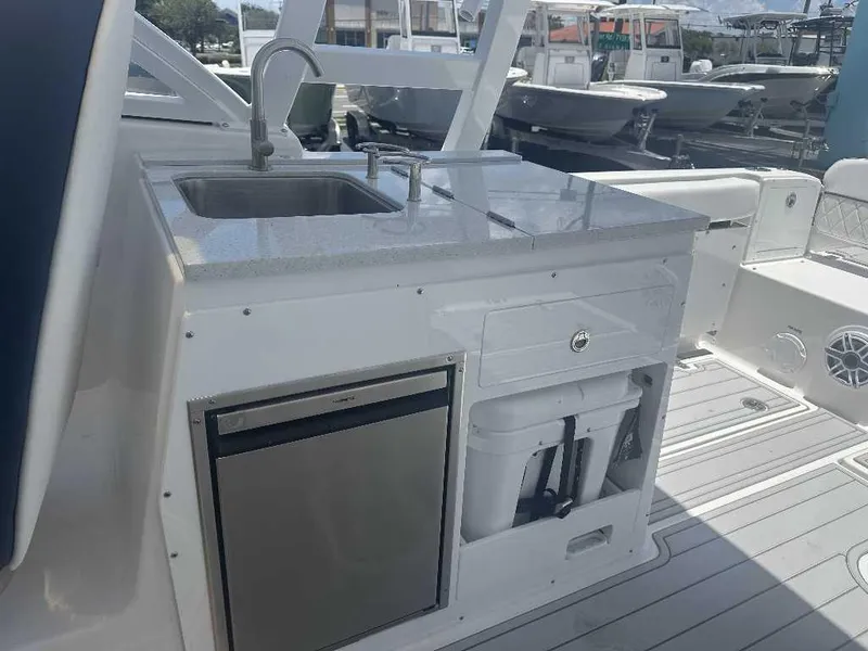 Slide: The Image of 2026 Sea Fox 288 Traveler boat kitchenette with sink, fridge, and storage compartments. - 4