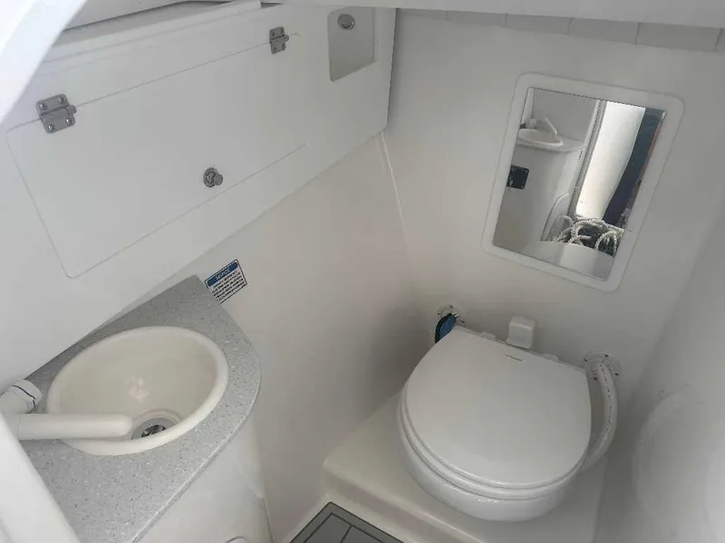 Slide: The Image of 2026 Sea Fox 288 Traveler boat bathroom with sink, toilet, and mirror. - 9