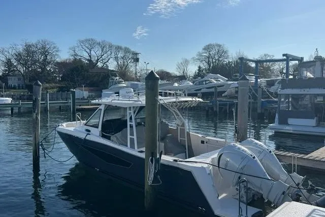 The Image of 2026 Solara S-310 CW boat docked at a marina under clear skies. - 0
