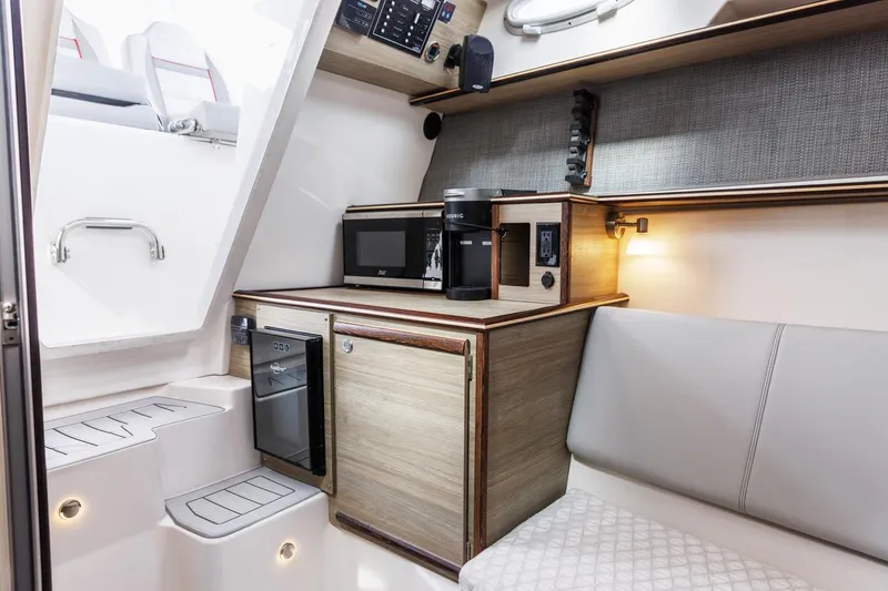 Slide: The Image of Modern interior of 2026 Solara S-310 CW boat with kitchenette and seating area. - 11