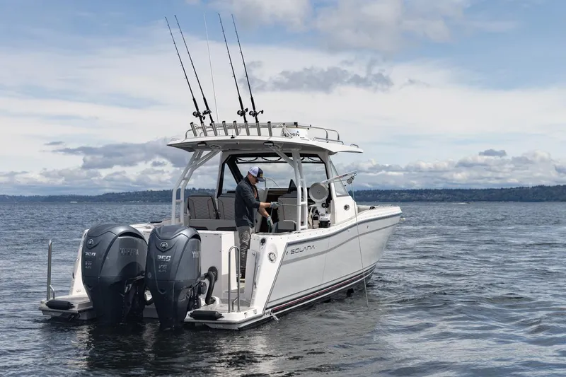 Slide: The Image of 2026 Solara S-310 CW boat on water with fishing rods and dual Yamaha engines. - 3