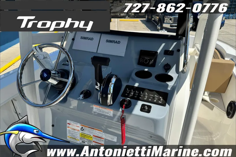 Slide: The Image of 2025 Trophy T20 CC boat dashboard with steering wheel and controls, featuring Simrad electronics. - 15