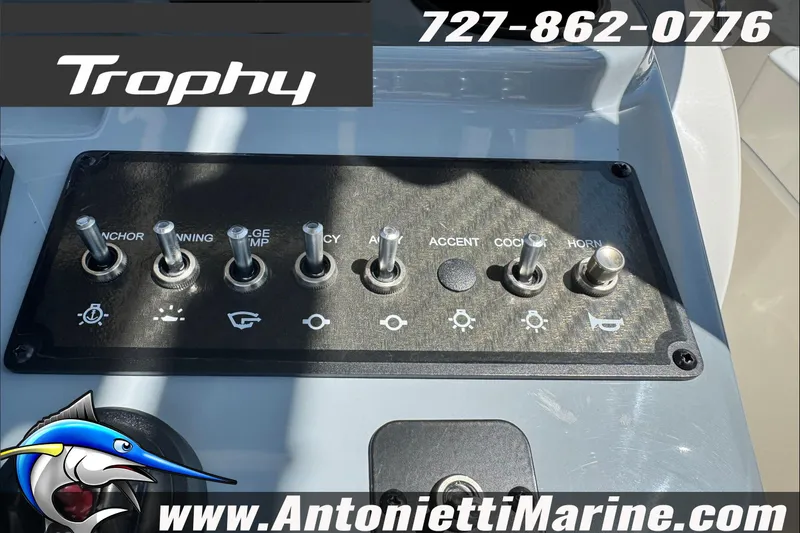 Slide: The Image of Control panel of 2025 Trophy T20 CC boat with various toggle switches. - 16