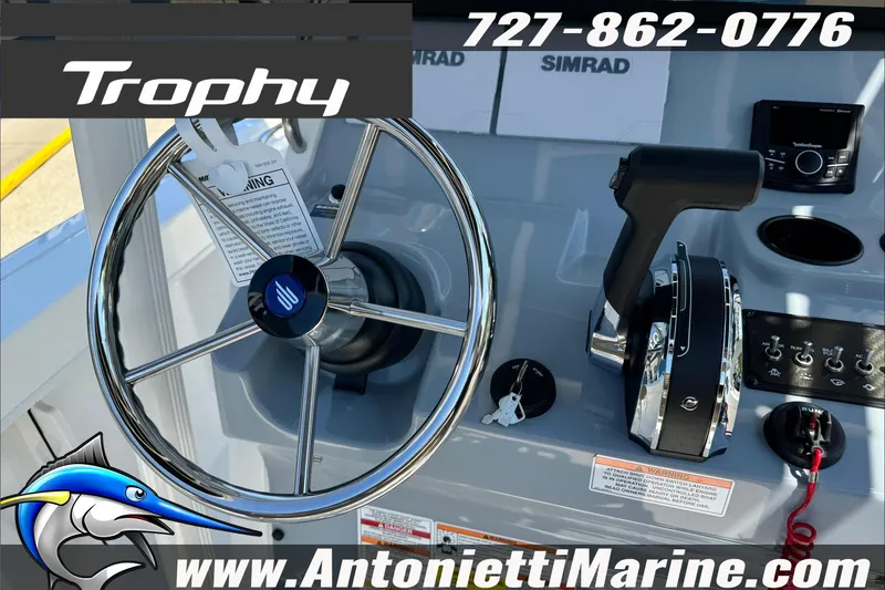 Slide: The Image of Steering console of 2025 Trophy T20 CC boat with controls and branding. - 19