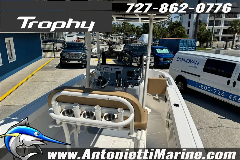 Slide: The Image of 2025 Trophy T20 CC boat at dealership, featuring console and seating, contact info displayed. - 9