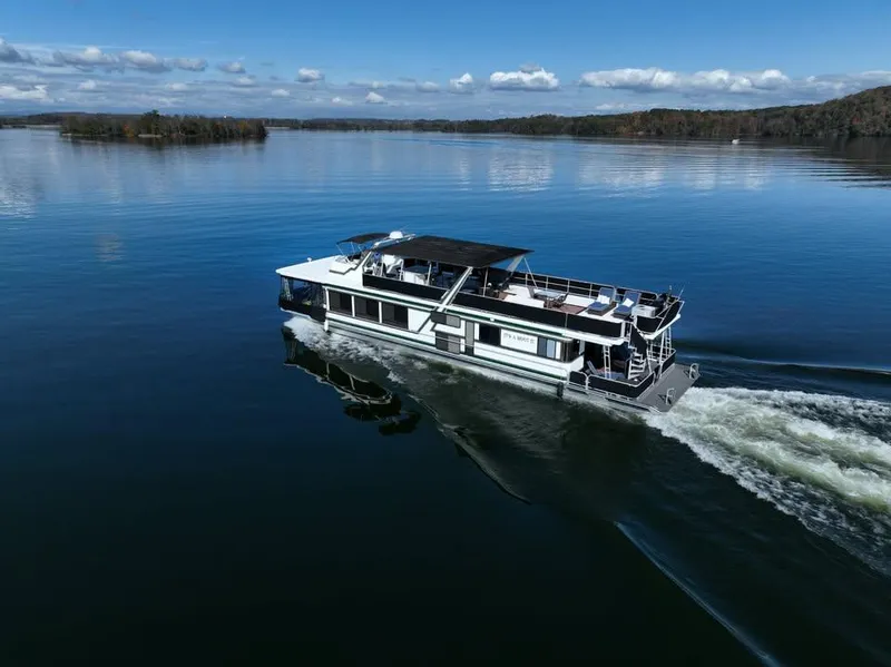 Slide: The Image of Sumerset 82'x 18' Widebody Houseboat cruising on a serene lake, 1996 model. - 0
