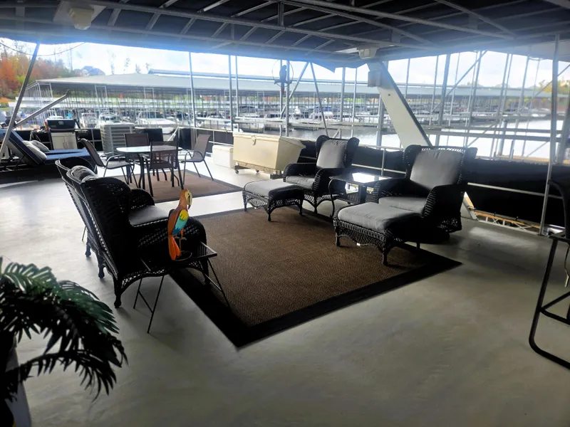 Slide: The Image of Spacious deck of 1996 Sumerset 82'x 18' Widebody Houseboat with outdoor seating and marina view. - 10