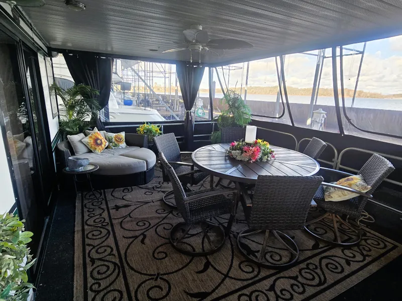 Slide: The Image of Luxurious 1996 Sumerset 82'x 18' houseboat interior with elegant seating and floral decor. - 14