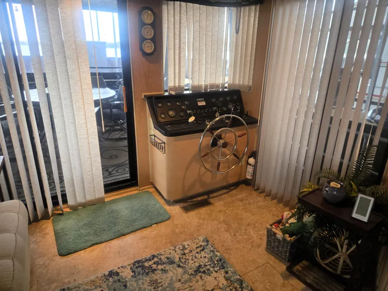 Slide: The Image of 1996 Sumerset 82'x 18' Widebody Houseboat helm with steering wheel and control panel. - 17