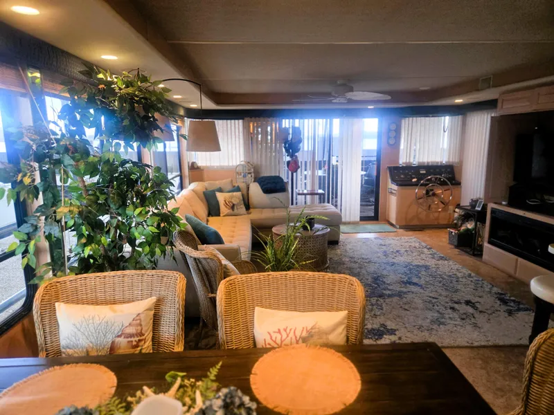 Slide: The Image of Luxurious interior of a 1996 Sumerset 82'x 18' Widebody Houseboat with cozy seating and decor. - 18