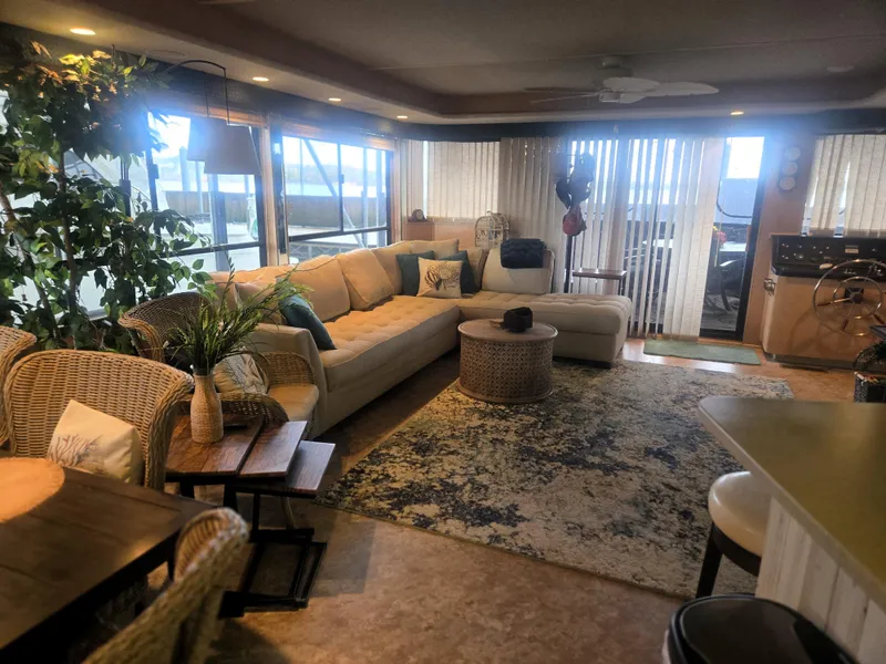 Slide: The Image of Luxurious interior of a 1996 Sumerset 82'x 18' Widebody Houseboat with cozy seating and decor. - 19
