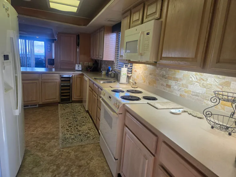 Slide: The Image of Kitchen interior of 1996 Sumerset 82'x 18' Widebody Houseboat with modern appliances. - 21