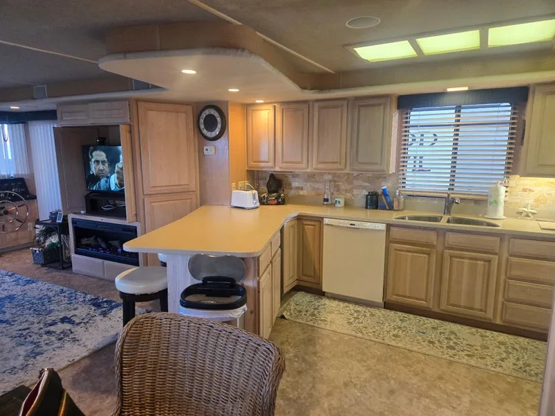 Slide: The Image of Interior of 1996 Sumerset 82'x 18' Widebody Houseboat with modern kitchen and cozy living area. - 24