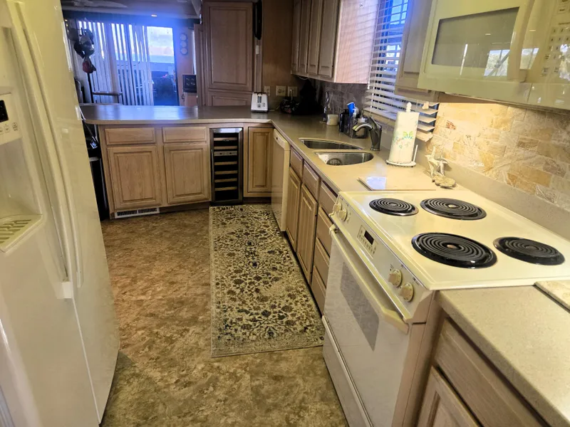 Slide: The Image of Kitchen interior of 1996 Sumerset 82'x 18' Widebody Houseboat with modern appliances. - 25