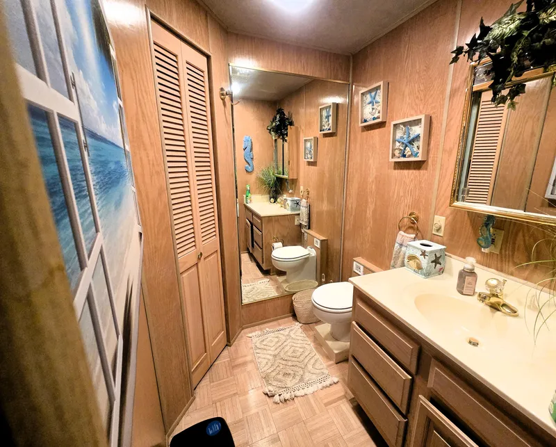 Slide: The Image of Cozy bathroom in 1996 Sumerset houseboat with wood paneling and nautical decor. - 26
