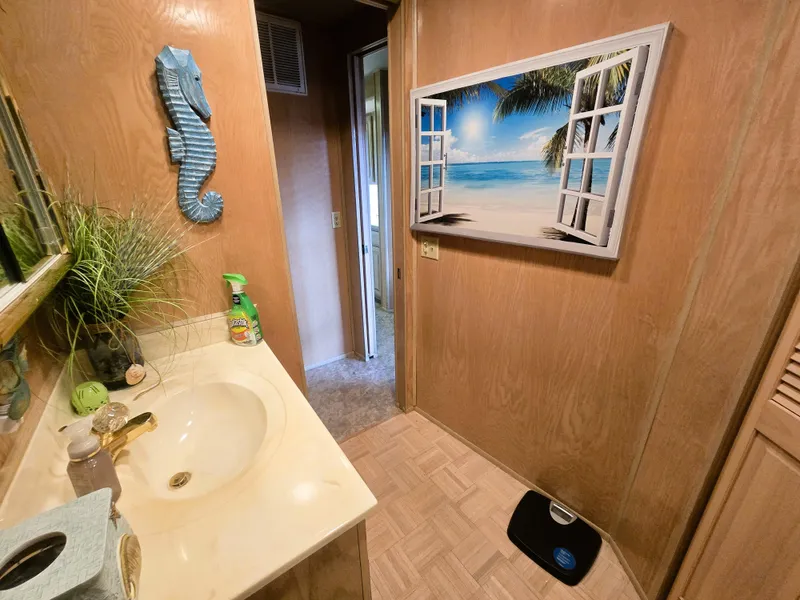 Slide: The Image of Bathroom interior of 1996 Sumerset houseboat with beach-themed decor and wooden paneling. - 27