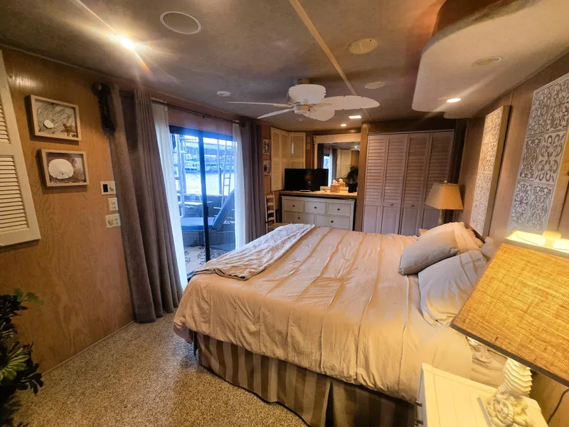 Slide: The Image of Cozy bedroom in a 1996 Sumerset 82'x 18' Widebody Houseboat with elegant decor. - 29