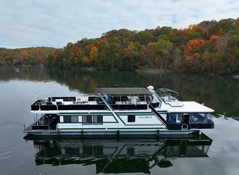 Slide: The Image of 1996 Sumerset 82'x 18' Widebody Houseboat on a serene lake with autumn foliage. - 3