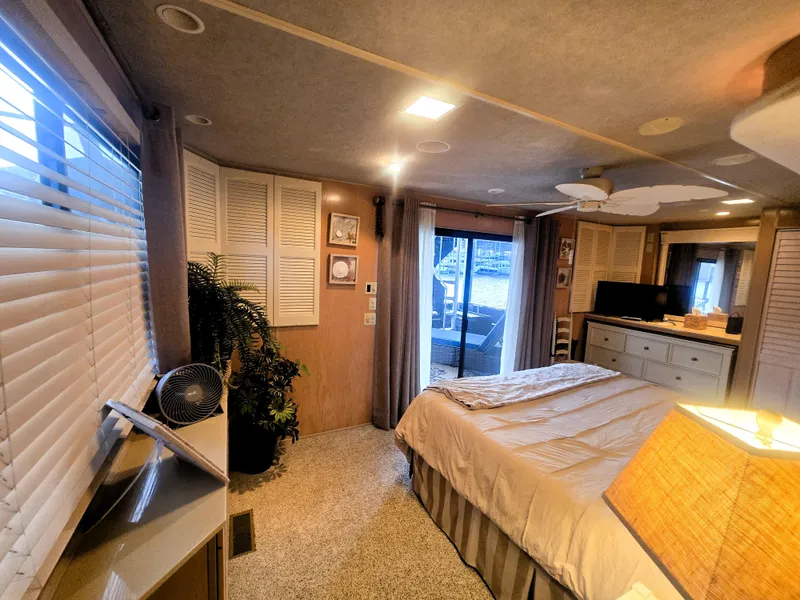 Slide: The Image of Cozy bedroom in a 1996 Sumerset 82'x 18' Widebody Houseboat with modern decor. - 30