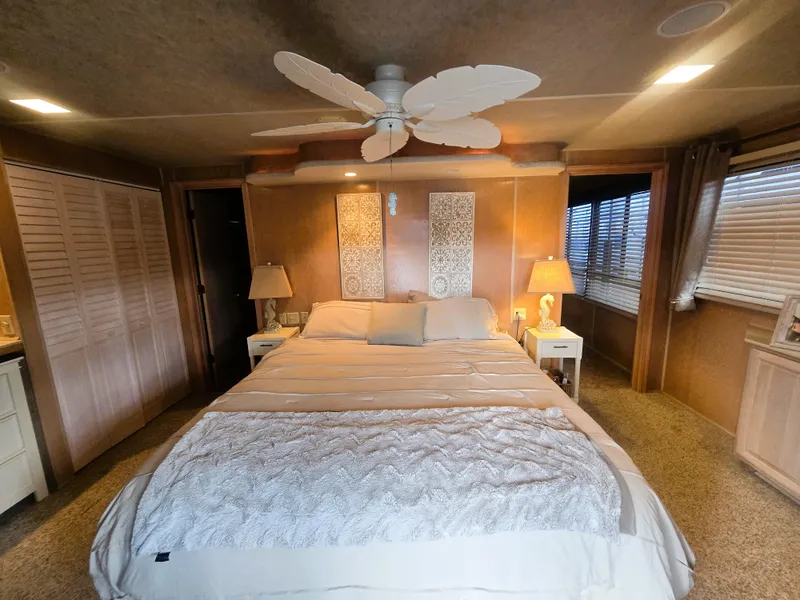 Slide: The Image of Luxurious bedroom in a 1996 Sumerset 82'x 18' Widebody Houseboat, featuring elegant decor. - 31