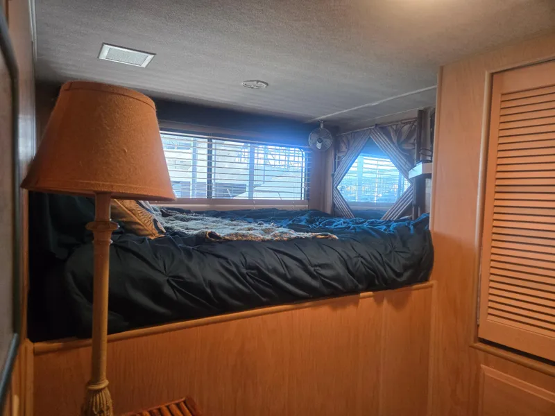 Slide: The Image of Cozy bedroom interior of 1996 Sumerset 82'x 18' Widebody Houseboat with bed and lamp. - 35