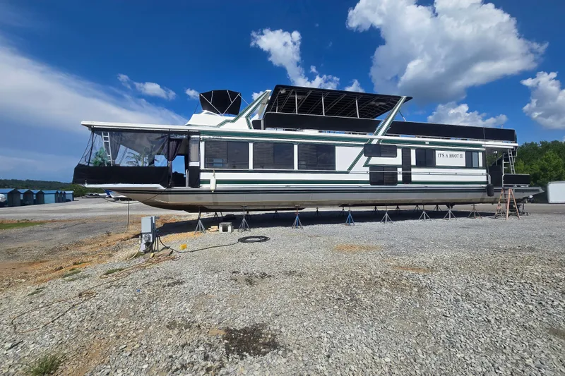Slide: The Image of 1996 Sumerset 82'x 18' Widebody Houseboat on land under a clear blue sky. - 39