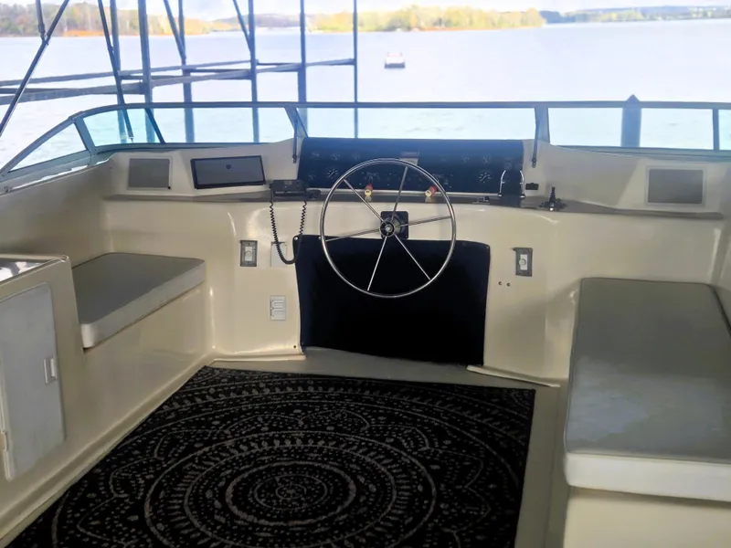 Slide: The Image of 1996 Sumerset 82'x 18' Widebody Houseboat helm with lake view and seating area. - 4