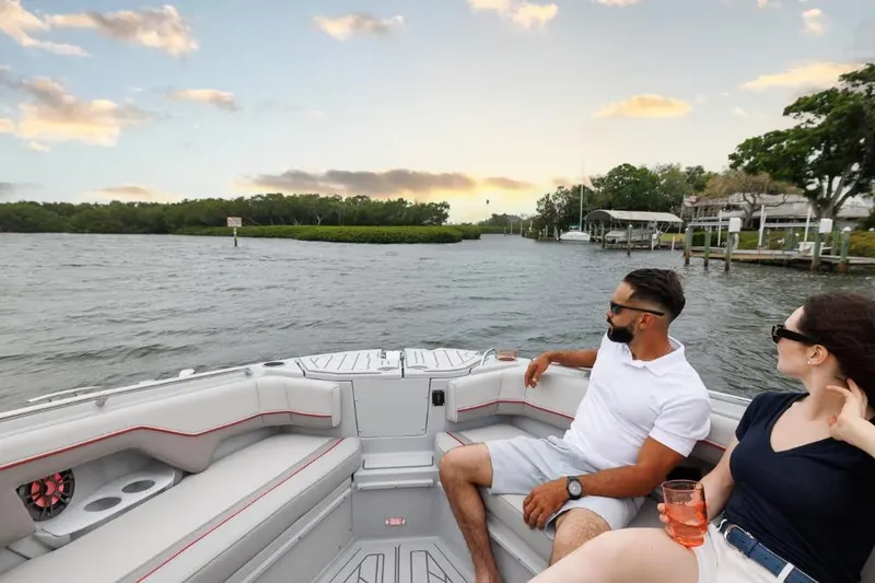 Slide: The Image of Couple enjoying a sunset cruise on a 2026 Solara S-310 Sport Coupe boat. - 17