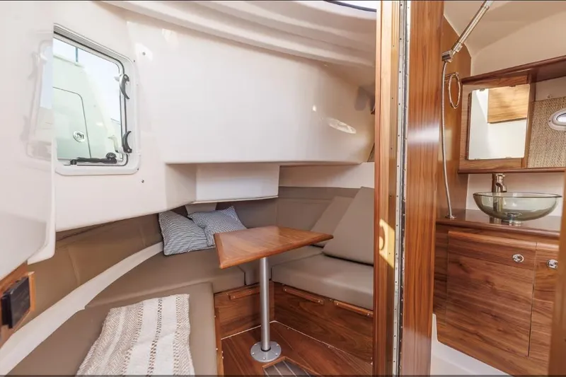 Slide: The Image of Interior of 2026 Solara S-310 Sport Coupe, featuring cozy seating and elegant wood finishes. - 18
