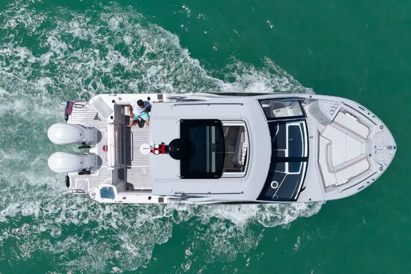 Slide: The Image of Aerial view of 2026 Solara S-310 Sport Coupe cruising on turquoise water. - 19