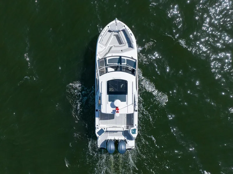 Slide: The Image of Aerial view of 2026 Solara S-310 Sport Coupe cruising on water. - 2