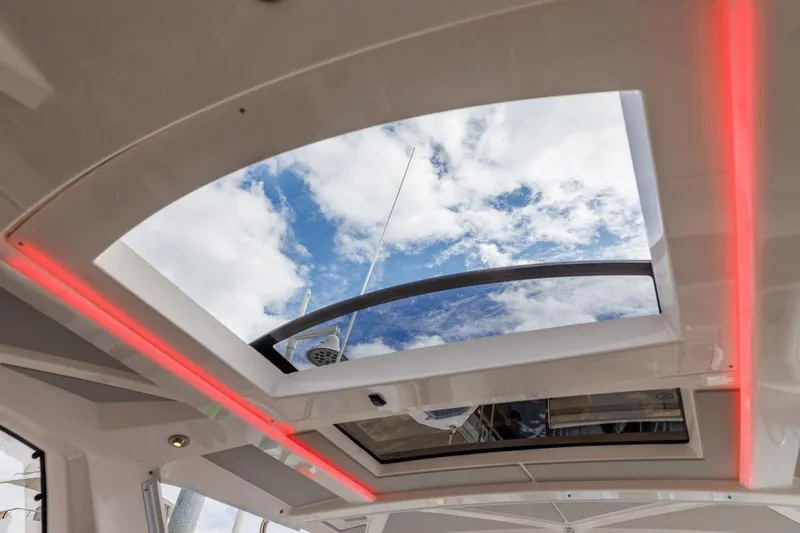 Slide: The Image of 2026 Solara S-310 Sport Coupe sunroof with sky view and modern interior lighting. - 9