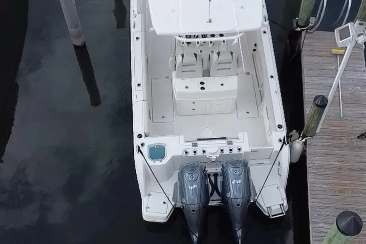 Slide: The Image of Aerial view of a 2019 Sailfish 270 boat docked with twin outboard motors. - 8