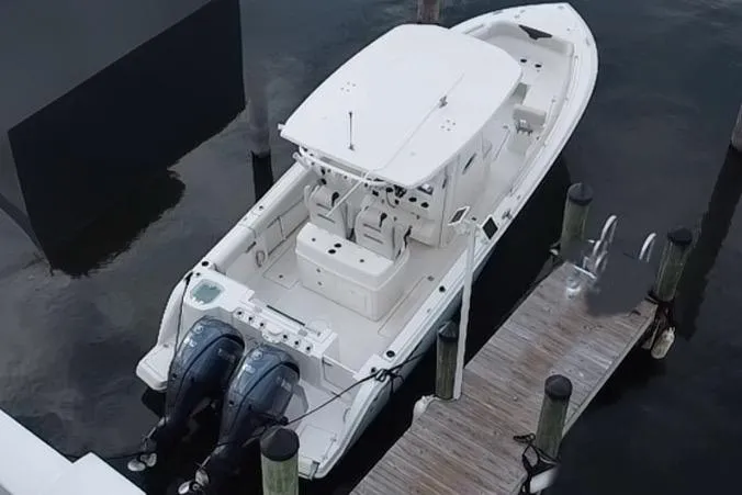 Slide: The Image of 2019 Sailfish 270 boat docked with dual outboard motors. - 9
