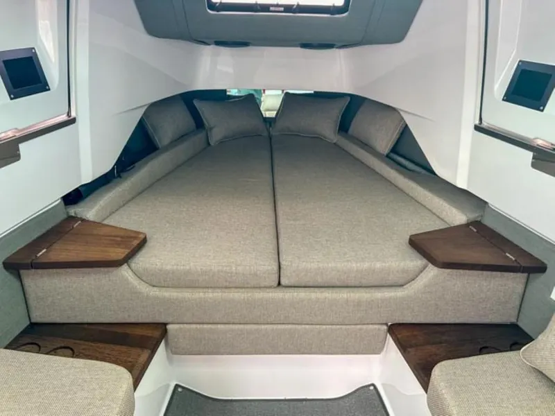 Slide: The Image of 2024 Axopar 37XC CROSS CABIN interior with cozy sleeping area and modern design. - 11
