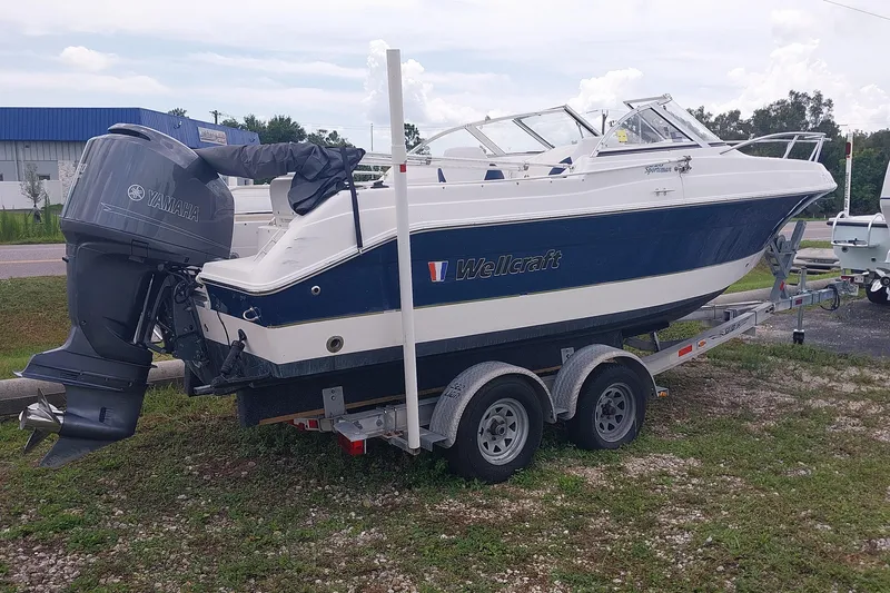Slide: The Image of 2008 Wellcraft 220 Sportsman boat on trailer with Yamaha outboard motor. - 2