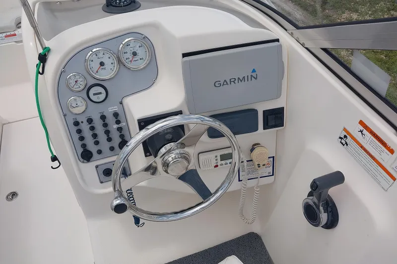 Slide: The Image of 2008 Wellcraft 220 Sportsman boat dashboard with Garmin navigation system and control gauges. - 5
