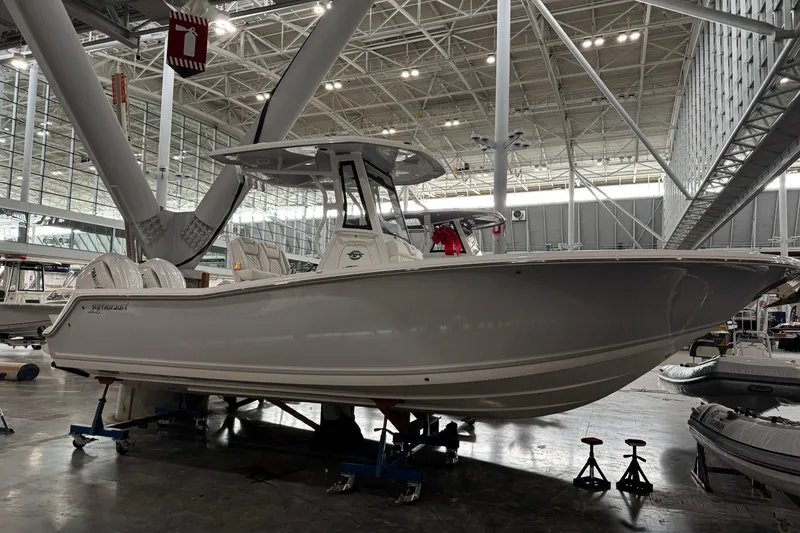 The Image of 2026 Tidewater 256 CC Adventure boat displayed indoors at a boat show. - 0