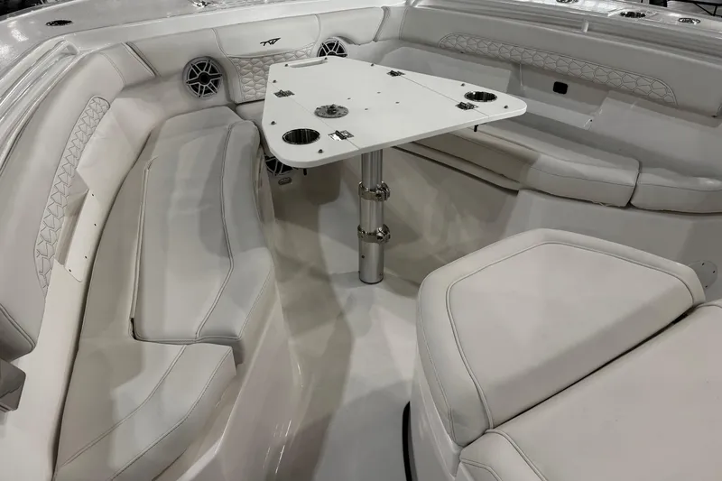 Slide: The Image of 2026 Tidewater 256 CC Adventure boat interior with seating and table setup. - 13