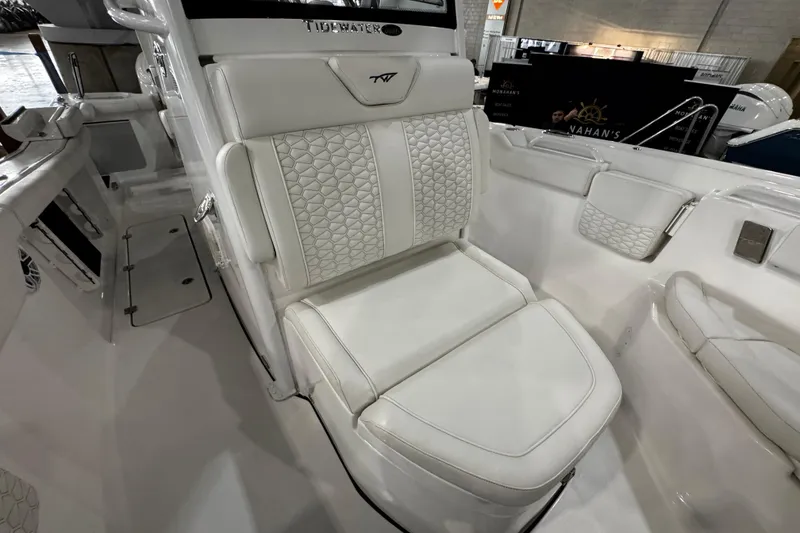 Slide: The Image of 2026 Tidewater 256 CC Adventure boat interior with white seating and table. - 14