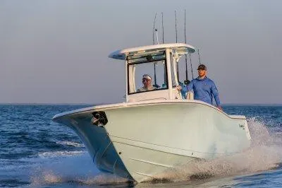 Slide: The Image of 2026 Tidewater 256 CC Adventure boat with custom detailing in a showroom. - 3